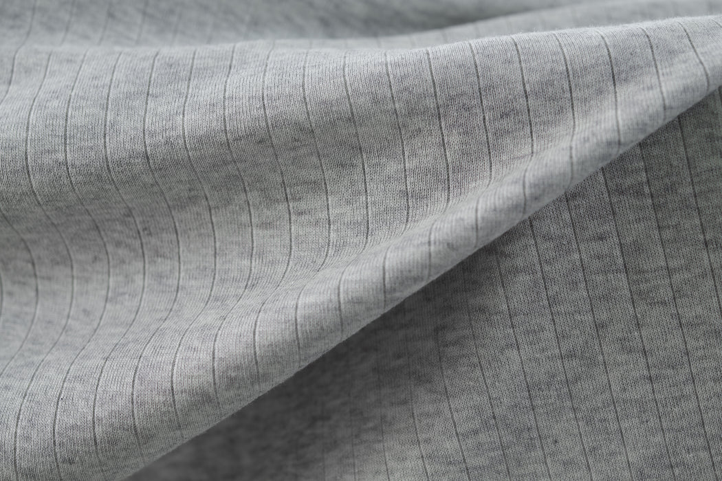 Heather gray colored ribbed knit fabric made from cotton.