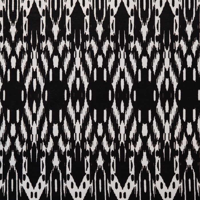Jersey fabric with a black and white ikat print made from rayon and spandex.