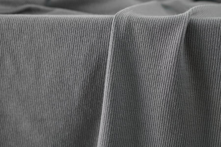 Silver colored ribbed knit fabric made from rayon and lycra.