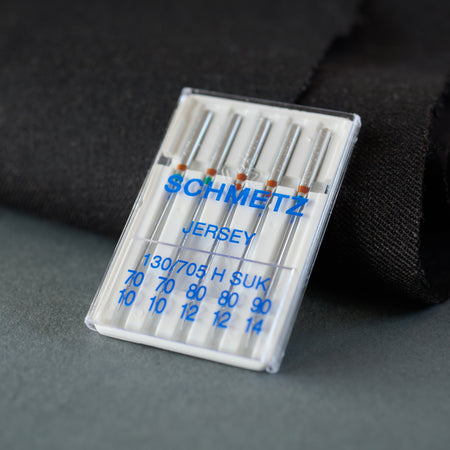 A pack of five assorted Schmetz ballpoint needles.