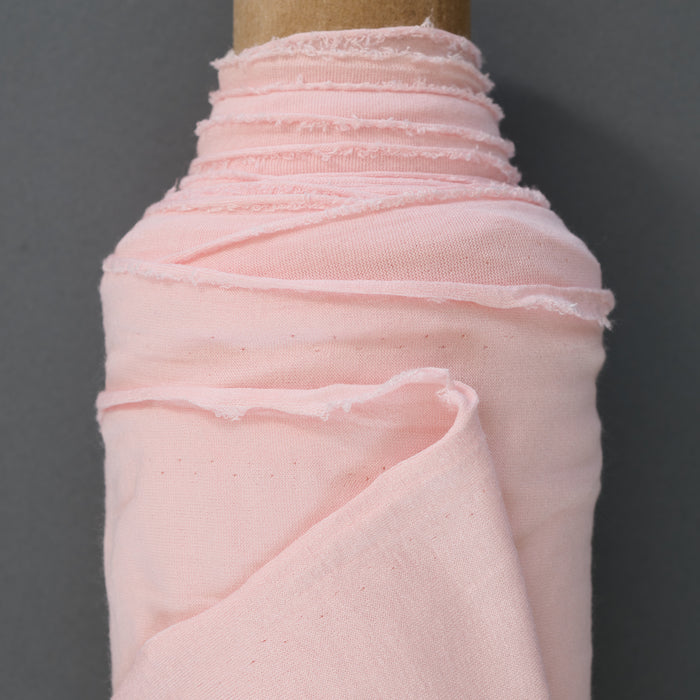 Light pink colored jersey fabric made from rayon and spandex.