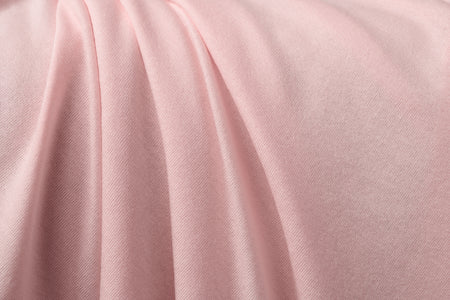 Light pink colored jersey fabric made from rayon and spandex.